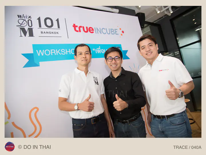 Three people give thumbs-up gestures in front of a workshop backdrop with Whizdom 101 and True Incube logos.