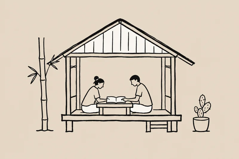 A group looks through a notebook beside a rural home, with bamboo and a cactus growing nearby.